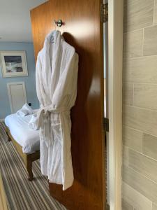 a robe hanging on a door in a bathroom at The Barge Tarbert in Tarbert