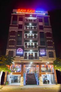 a tall building with a sign on it at night at San San Hotel Da Nang in Da Nang