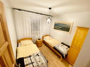 Postel nebo postele na pokoji v ubytování Apartamenty Nad Dunajcem koło Zakopanego