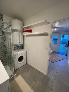 a laundry room with a washing machine and a washer at Studio entre lac et océan à Hossegor in Soorts-Hossegor