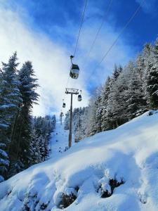 a ski lift on a snow covered slope at Studio au coeur de la Station de Ski in Saint-Aventin