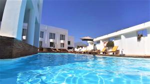 a swimming pool in front of a hotel at CITY WALLS rooftop terrace duplex @ citycenter & beach in Lagos