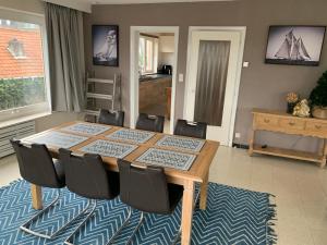 a dining room with a wooden table and chairs at Vakantie-appartement Lauren XL Westende in Middelkerke