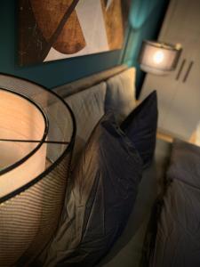 a bed with two pillows sitting next to a lamp at H-85 SUITES LEVEL 2/4 in Koblenz
