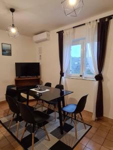 a living room with a dining room table and chairs at Apartments Solis, 50 m from the sea - Jakišnica in Jakišnica