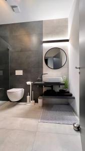 a bathroom with a sink and a mirror at H-85 SUITES Level 5/9 in Koblenz