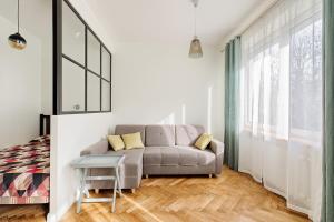 a living room with a couch and a bed at Art & Comfort Home in Kaunas