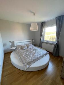 a bedroom with a large bed with a large window at Apartman Vera in Kremna