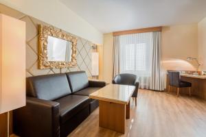 a living room with a couch and a table at Hotel Weißes Kreuz in Bregenz