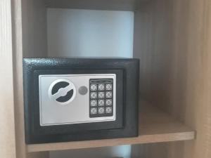 a microwave oven sitting on top of a shelf at Apartman AMALFI in Nova Varoš