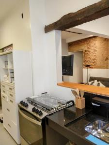 a kitchen with a counter with a stove top oven at Encanto do Pilar in Ouro Preto