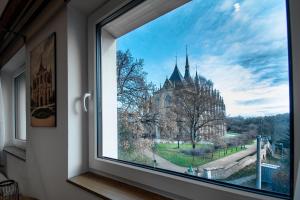 a window with a view of a church at Vista Apartments in Kutná Hora