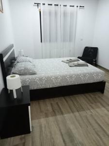a bedroom with a bed and a wooden floor at casa do mestre in Vieira do Minho