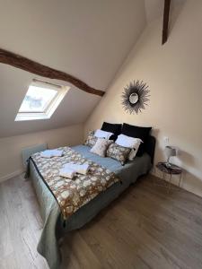 una camera da letto con un letto grande in una mansarda di Les Maisons d'Augustine, demeure de charme de la cour Ste Catherine a Honfleur