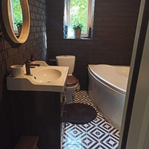 a bathroom with a sink and a tub and a toilet at Dom Skandynawski Sen in Wałcz +26 photos