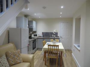 a kitchen and dining room with a table and chairs at Station Retreat 6B Comberton Terrace in Kidderminster