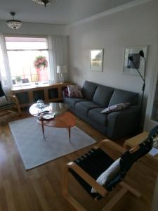 a living room with a couch and a table at Cozy two room apartment with sauna in Hyvinkää