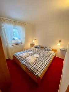 a bedroom with a bed with two towels on it at Apartmán pod lesem in Svoboda nad Úpou