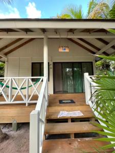 a porch of a house with a wooden deck at Sol y Arena Xcalak in Xcalak
