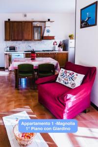 a living room with a red couch and a table at Il Tiglio Gressan CIR 0003-CIR 0041 in Aosta