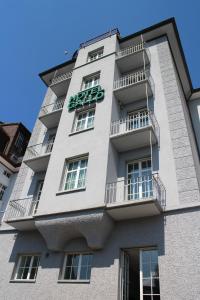 a tall white building with a sign on it at Boutique City Hotel Gallo in St. Gallen