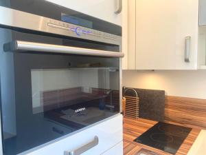 a kitchen with a microwave oven in a kitchen at Studio Inselblick für 2 mit Traumpanorama in Schliersee