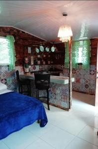 ein Schlafzimmer mit einem Bett und eine Küche mit einem Tisch in der Unterkunft Lita's Place in Cordillera Arriba