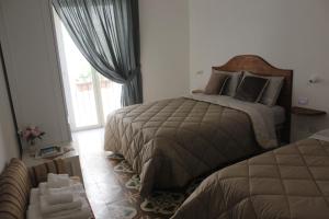 Postel nebo postele na pokoji v ubytování B&B Dei Cardinale