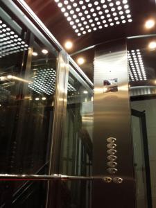 a elevator in a room with lights on the ceiling at Hostal Alistana in Madrid