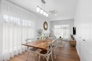 a dining room with a wooden table and chairs at Foxmount Estate - Astrid in Mount Gambier