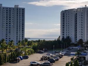a parking lot with parked cars and tall buildings at Playa Blanca Towncenter Suite - NO incluye comidas in Playa Blanca