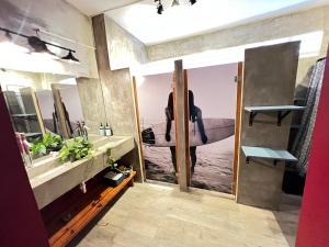 a bathroom with a mirror and a surfboard on the wall at Casa Coral in Luquillo +88 photos