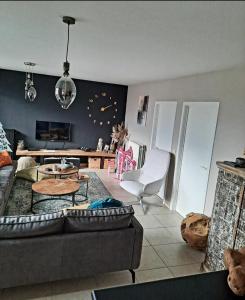 a living room with a couch and a table at loft appartement met 3 slaapkamers en gratis parking in Ichtegem