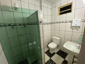 a bathroom with a shower and a toilet and a sink at Hotel Ype de São Carlos in São Carlos +51 photos