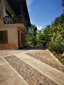 a stone walkway leading to a building at Hotel Boutique Albania in Otanche