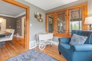 a living room with a blue couch and a table at Gorgeous Downtown Bungalow, Walk Everywhere!!! in Lake Geneva