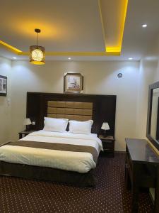 Ένα ή περισσότερα κρεβάτια σε δωμάτιο στο Nafal Hotel Suites