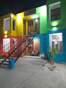 a colorful building with a staircase in front of it at Complejo Don Tito in San Juan