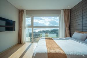 Postel nebo postele na pokoji v ubytování Y Resort Jeju