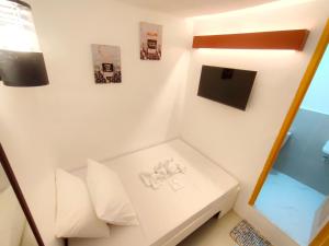 a living room with a white couch and a lamp at E Relaxed Haven Transient House in Manila