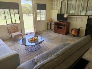 a living room with a couch and a table at Happy Pig Farm in Stanthorpe