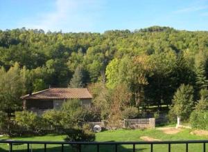 a house in the middle of a field with trees at LLANARS, en Vall de CAMPRODON Vistas Montaña de frente, ASCENSOR, Orientación Sur, Chimenea, WIFI, MOLLÓ PARK, VALLTER, HÍPICA, GOLF in Llanars