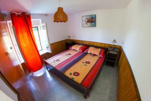 ein Schlafzimmer mit einem Bett mit einem Holzrahmen in der Unterkunft Apartments Stefanovski Paradiso in Veli Lošinj