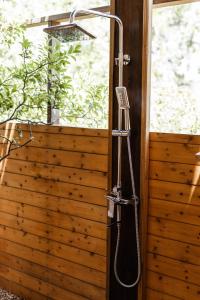 a shower in a bathroom with a wooden wall at Tribe Yala - Luxury Camping in Yala +121 photos