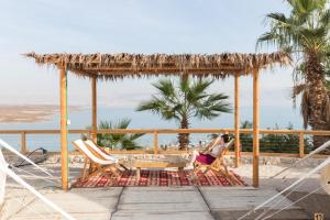 a couple of chairs on a deck with the beach at Glamping -420 in Kalia