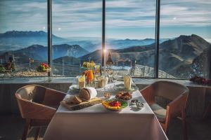 a table with food on it with a view of mountains at Noc na Chopku, Rotunda in Belá