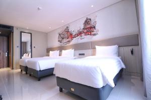 Postel nebo postele na pokoji v ubytování Prime Park Hotel & Convention Lombok