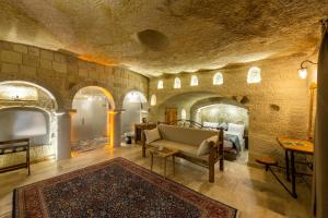 a living room with a couch and a rug at Charming Cave Hotel in Göreme
