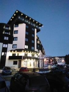 a building with lights on it in a parking lot at Lela Kop in Kopaonik
