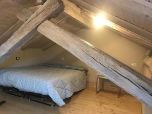 a bedroom with a bed in the attic at Appartamento Orta centro in Orta San Giulio